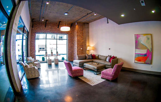 a living room with couches and chairs and a large window
