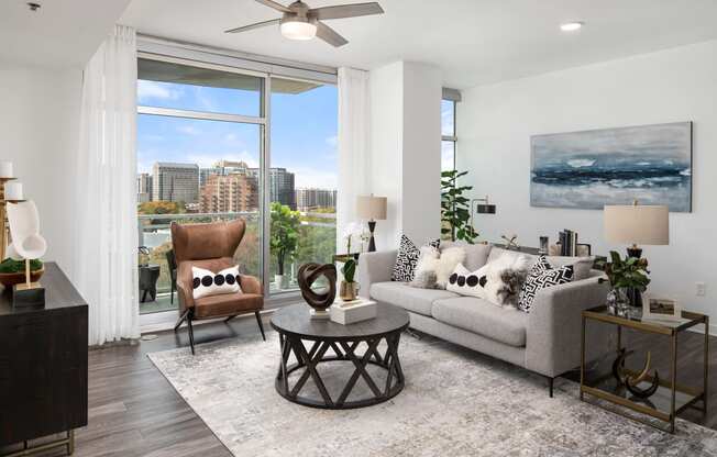 a living room with a couch and a chair and a window