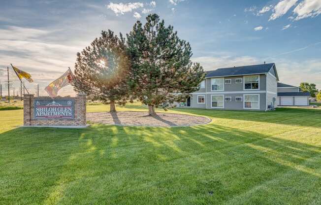 the yard of a house with a tree and a sign at Shiloh Glen, Billings, 59102