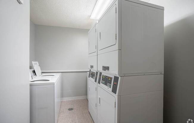 a white kitchen with white appliances and a white counter top