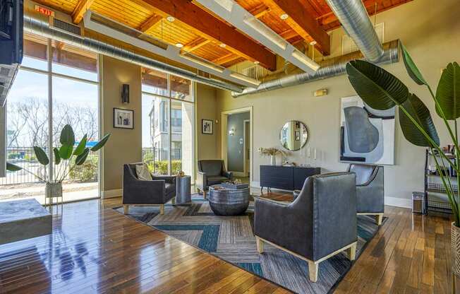 A living room with a wooden floor and a large window.