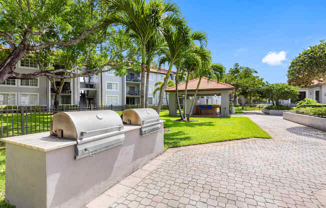 A sunny day at a residential area with a brick pathway and a row of houses.