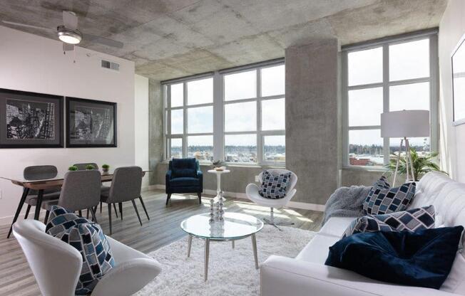 Apartments for Rent in Oakland-Aqua Via Apartments Living Room With Large Windows With City View And Vinyl Plank Flooring