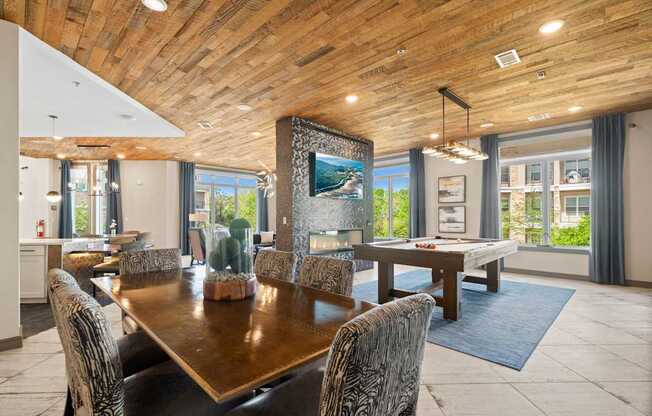 A modern dining room with a wooden table and chairs.
