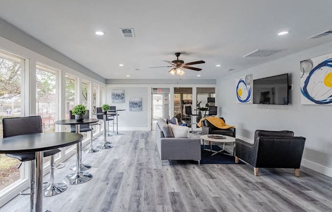 a living room with couches and chairs and a tv