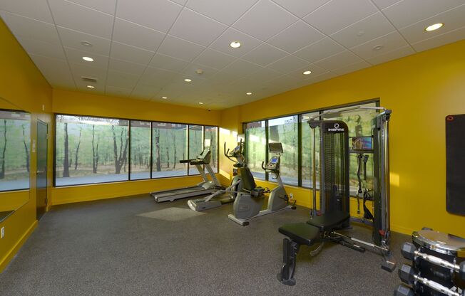 A gym with a variety of equipment including a treadmill, weights, and a bench. at 603 Concord Apartments, Cambridge