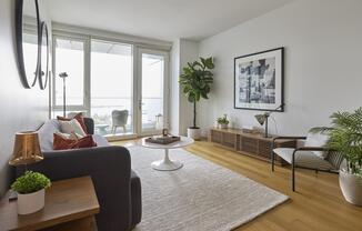 a living room filled with furniture and vase of flowers on a table