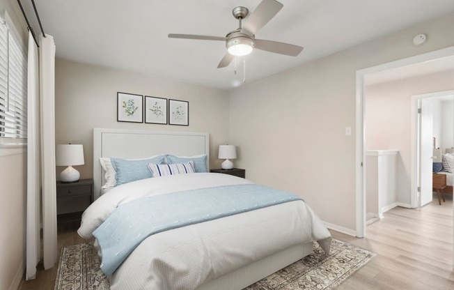 a bedroom with a bed and a ceiling fan