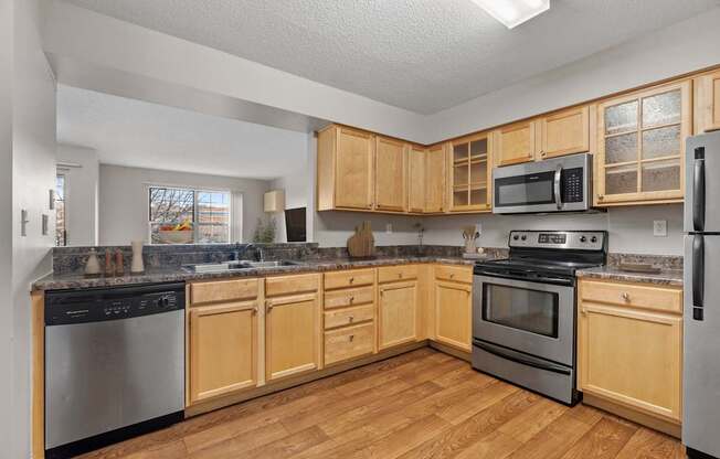 A kitchen with wooden cabinets and stainless steel appliances.