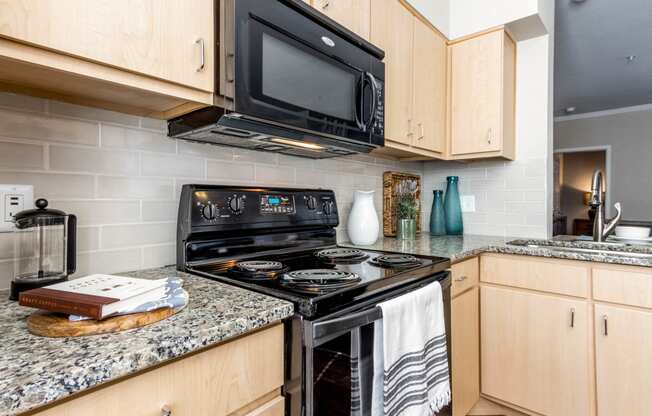a kitchen with black appliances and granite counter top