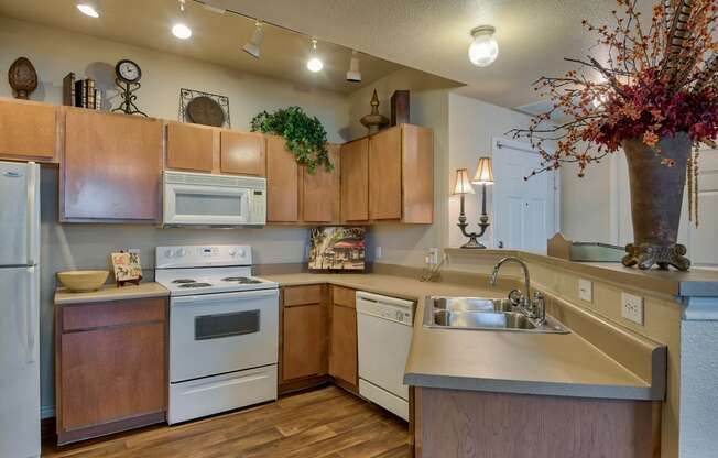 a kitchen with white appliances and wooden cabinets