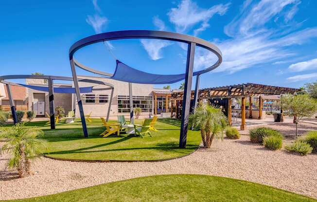 a playground with chairs and a canopy in front of a building