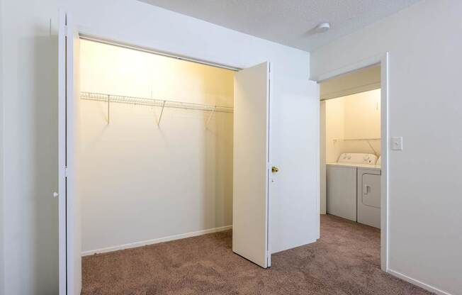 A bedroom with a white door open to a bathroom at Spring Creek Townhomes Apartments, Springfield