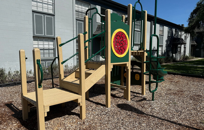 Inviting outdoor playground with a colorful climbing structure, perfect for family fun in a well-maintained residential community.