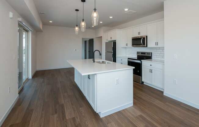 a large white kitchen with a large island in the middle at The Crossings at Windsong, Arizona