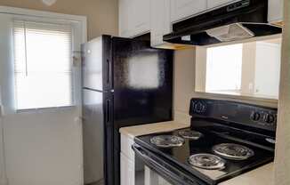 Updated Kitchen With Black Appliances at Hibiscus Place Apartments, Orlando, 32808