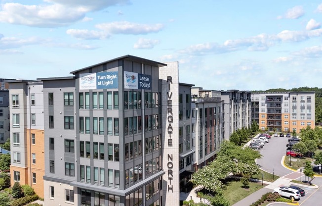 a large apartment building with a parking lot in front of it