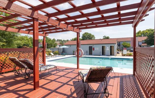 our apartments have a large pool and a deck with chairs