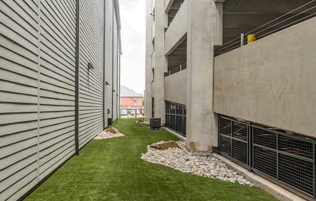 A concrete building with a green lawn in front.