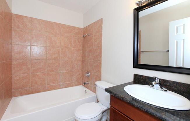 a white sink sitting under a mirror