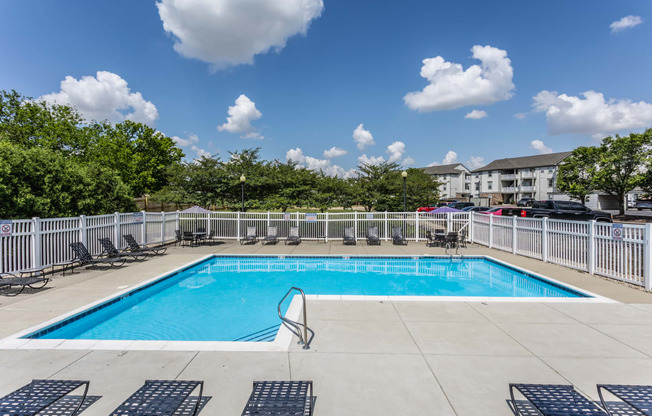 Indianapolis, IN Apartments - Riverchase - Sparkling Pool With Sundeck, Lounge Chairs, Tables With Umbrellas, And Apartment Homes In The Background