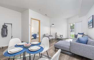a living room with a table and chairs and a couch  at Shoreline Village, Richland, WA