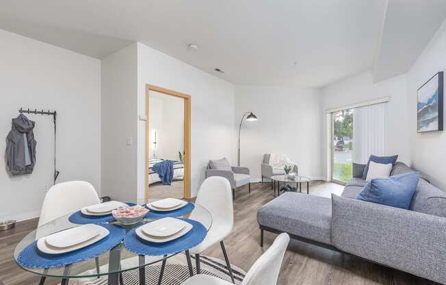a living room with a table and chairs and a couch  at Shoreline Village, Richland, WA