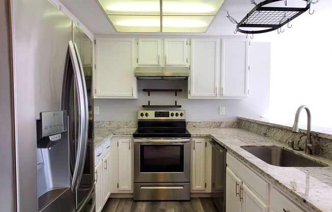 Upstairs Condo with 2 Car Garage, Fresh Paint, Wood Floors, Large Patio, Pool!