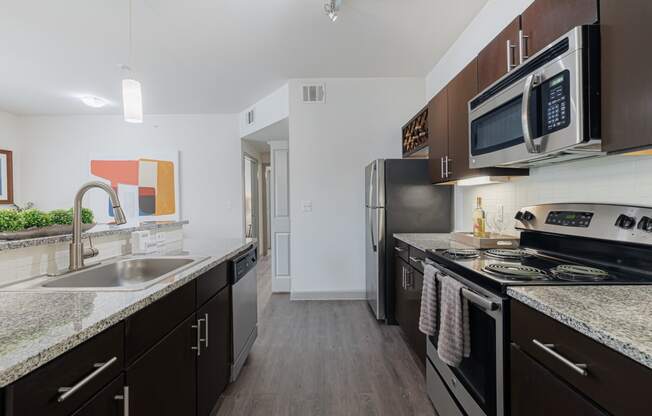 a kitchen with stainless steel appliances and granite counter tops and