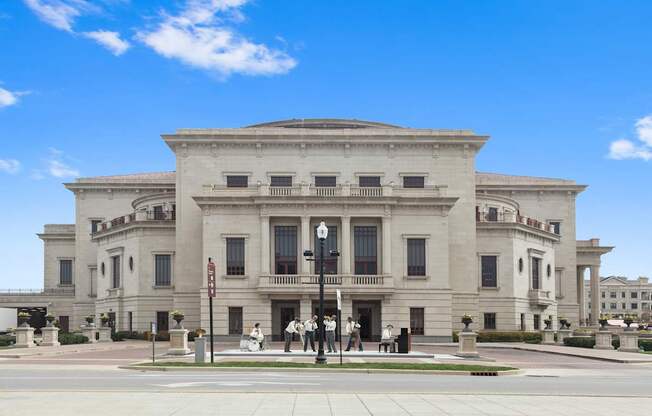 a large white building with people standing in front of it