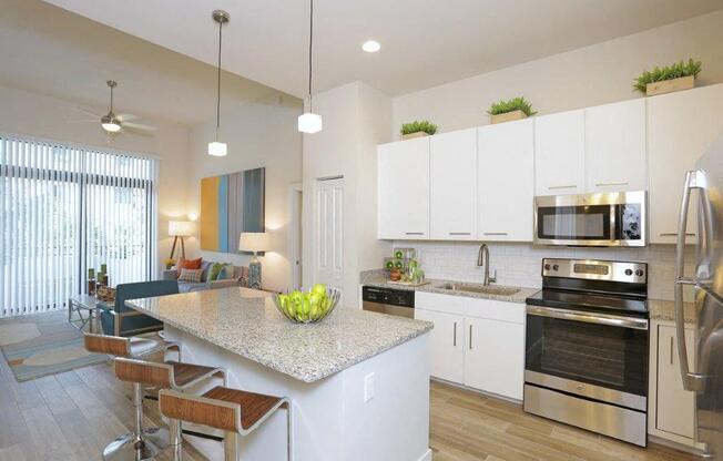 a kitchen and living room with a marble counter top