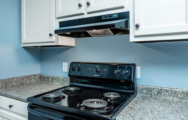 a stove top oven sitting inside of a kitchen