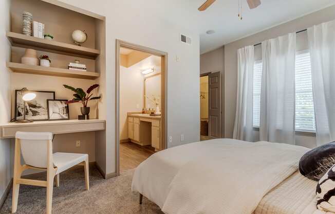 a bedroom with a bed and a desk with a mirror at Reserve by the Lake, Houston, Texas