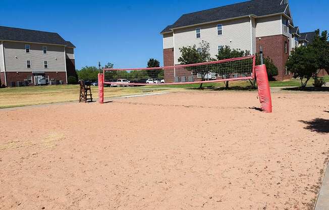 a sand volleyball court in front of a house
