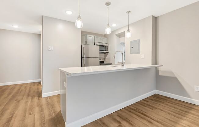 a kitchen with a large counter top and a refrigerator