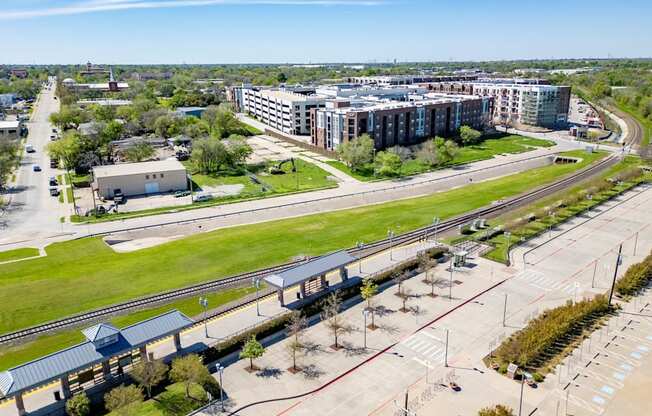 an aerial view of a city with buildings and train tracks