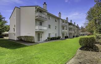 Exterior View of Apartments with Green Grassy Area at Campo Basso Apartment Homes, Lynnwood