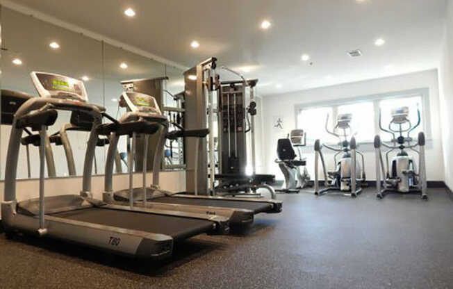 a gym with treadmills and other exercise equipment