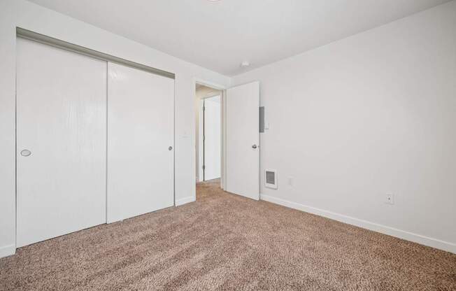 A room with carpeted floor and white walls.