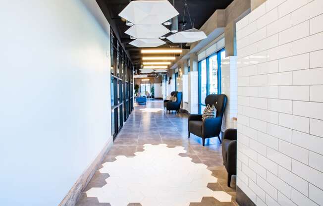 a long corridor with blue chairs and white tile on the floor at 511 Meeting, Charleston, South Carolina