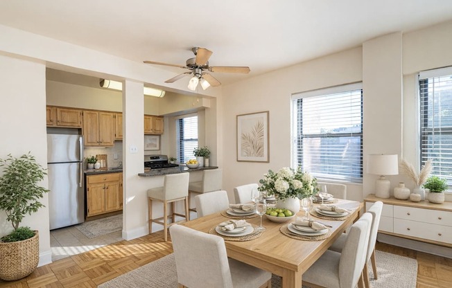 A dining room with a table set for a meal.
