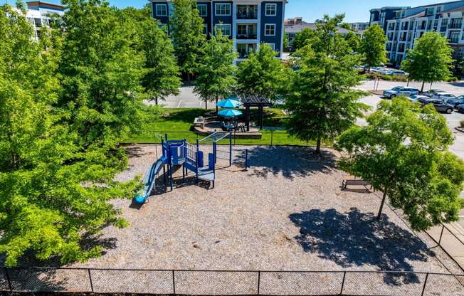 an aerial view of a playground in a park with trees