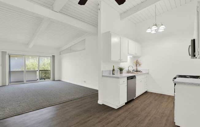 an open kitchen and living room with white walls and wood floors  at Willow Tree Apartments, Torrance, CA, 90505