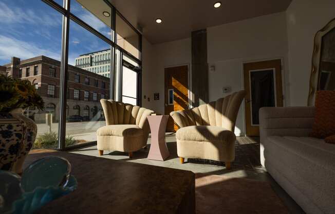 a living room with chairs and a table and a large window at The Lady, South Carolina