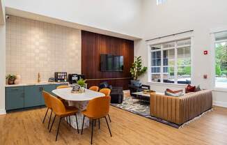 a living room and dining room with a table and chairs