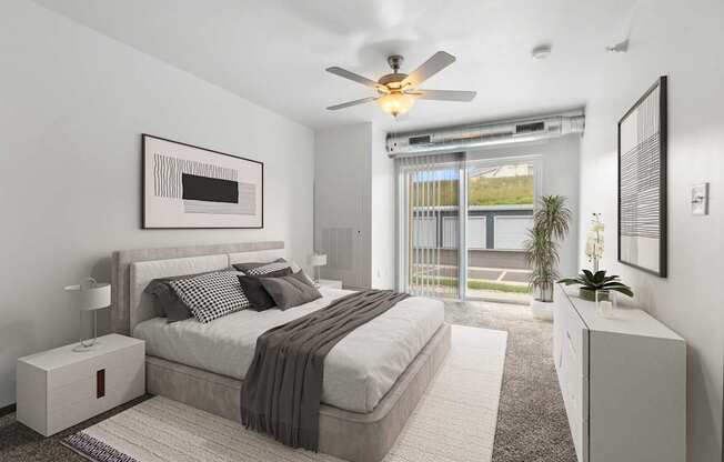 A bedroom with a large bed and a ceiling fan.