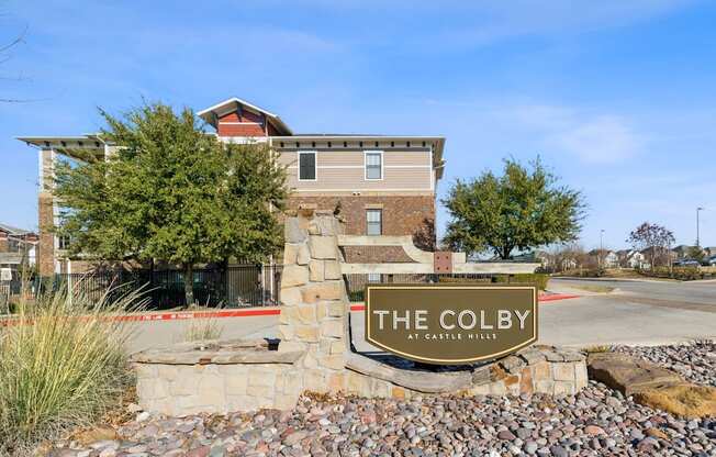 The Colby at Castle Hills is a modern building with a stone entrance.