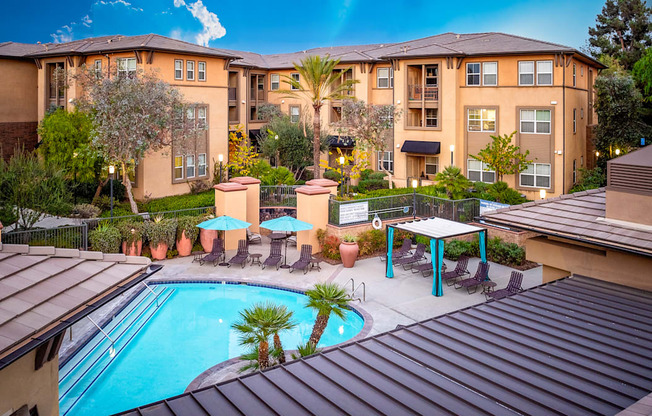 A large apartment complex with a pool and patio area.