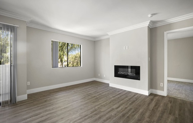 Apartments in Sherman Oaks CA - Open Space Living Room Showing Plenty of Natural Light With Hardwood Floor Featuring a Fireplace