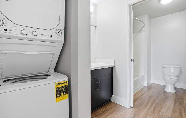 A white washing machine with a yellow sticker on it.